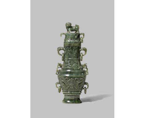 A CHINESE SPINACH-GREEN JADE ARCHAISTIC VASE AND COVER LATE QING DYNASTY Carved with taotie masks and loose rings, the cover 