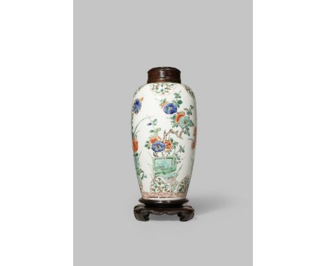 A CHINESE FAMILLE VERTE VASE KANGXI 1662-1722 With a slender ovoid body painted with four floral sprays sprouting from rockwo