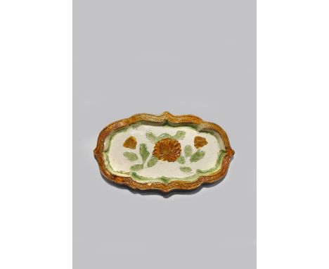 A CHINESE SANCAI TRAY LIAO DYNASTY The body moulded as a cartouche, decorated to the centre with a yellow lotus flowerhead an