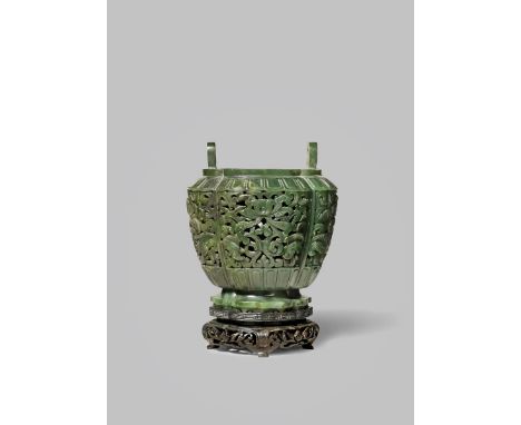 A CHINESE SPINACH-GREEN JADE RETICULATED VASE 18TH CENTURY With a quatrefoil body carved with stylised lotus flowerheads and 