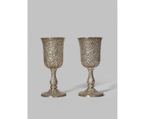 A PAIR OF INDIAN SILVER GOBLETS 19TH CENTURY Each with a chased and repoussé decoration of hunting animals amongst scrolling 