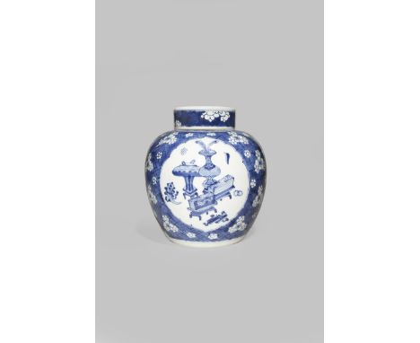 A CHINESE BLUE AND WHITE JAR AND COVER KANGXI 1662-1722 With an ovoid body painted with three flower-shaped panels with the '
