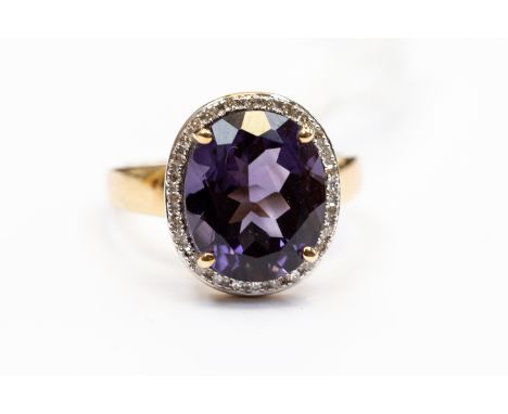 An amethyst and diamond oval cluster ring, the oval amethyst approx 11 mm x 10 mm, with a diamond set surround, 9ct gold, siz