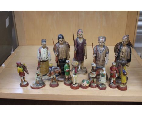 A collection of Indian/Burmese Figures in traditional dress. 5 larger sized figures carrying spears and sheilds approx 15cm i