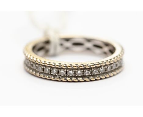 A diamond eternity ring, claw set with round brilliant cut diamonds, in 18 ct white gold, rope edge, width approx 3.5 mm, siz