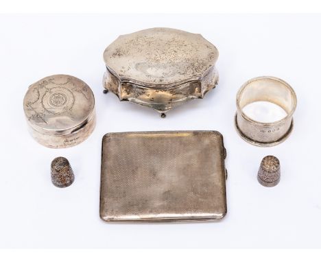 A collection of assorted silver comprising patch box, circular lidded box (AF), napkin ring and a cigarette case with engine 