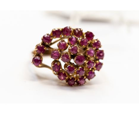 A ruby cluster dress ring, tiered sweeping design set with round cut rubies, set in gilt metal, size O½