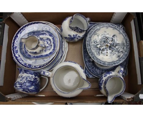 A collection of assorted blue and white ceramics including graduated jugs, various plates, Spode, a butter dish, plus various