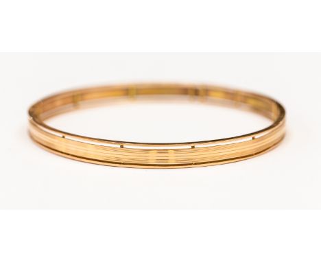 A rose gold bangle, stamped 15ct, internal diameter approx 70 mm, weight approx 16.6 gms