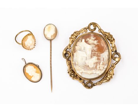 Four items of Victorian gilt metal cameo  jewellery comprising a large oval swivel brooch, a stick pin, a small brooch and a 