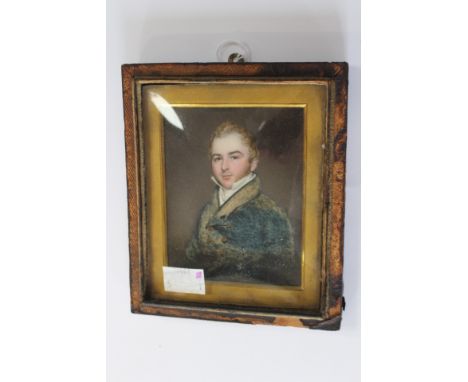  A mid 19th Century portrait miniature on ivory, a young gentleman, half length, wearing a white stock and blue tunic, 10cm b