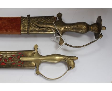 Pair of Indian made decorative Swords: The first has a curved 76cm long fullered single edged blade with etched decoration an