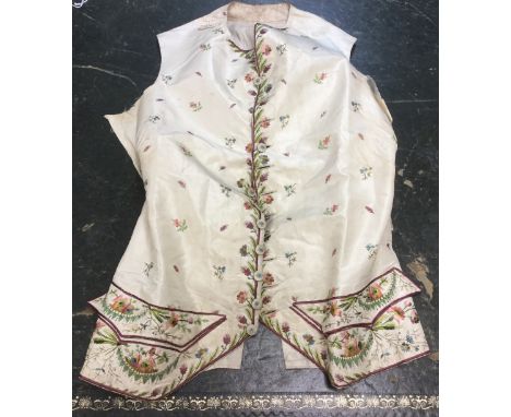 A late Georgian or early Regency waistcoat in a silk/taffeta fabric, hand embroidered with small sprigs of flowers decorating