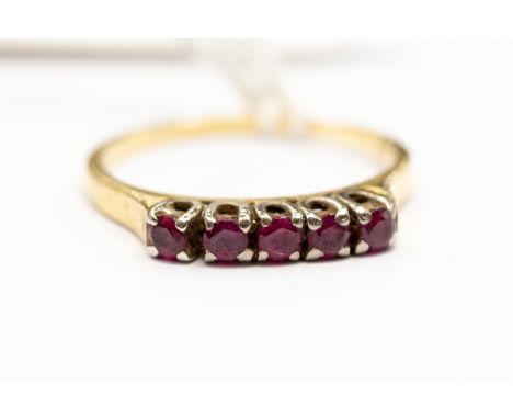 An 18 ct gold 5 small ruby set ring