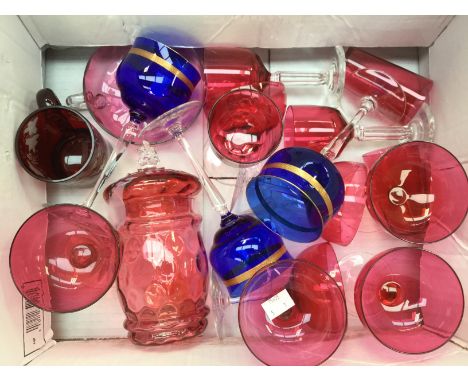 Collection of Cranberry glasses and glassware including champagne cups, lidded bonbon jar, and blue hock line glasses