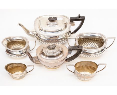 An Edwardian silver three piece tea service comprising teapot, sugar bowl and milk jug with gadroon border above, gadroon low