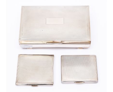 An Art Deco style silver table cigarette casket, engine turned, fitted interior (missing divider) Birmingham, 1990 and two en