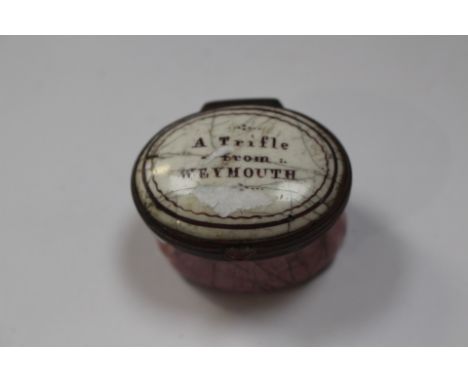An 18th Century Bilston enamel oval patch box, circa 1780, the cover with motto 'A Trifle from Weymouth', mirrored inner cove
