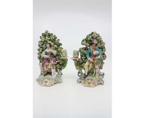 A pair of Derby patch mark figural candlesticks, circa 1760-65, modelled as shepherd and shepherdess musicians before bocage,