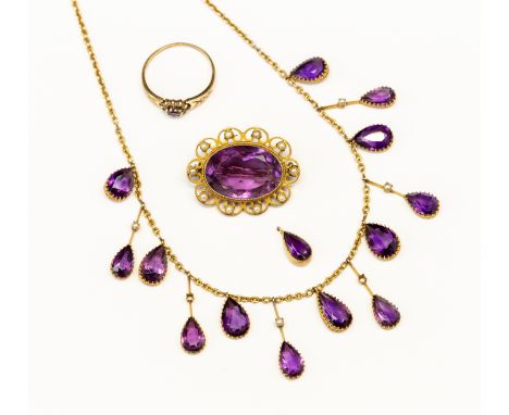 An Edwardian 9ct gold and  amethyst and pearl set fringe necklace, set with fourteen (one detached) pear cut amethysts set to