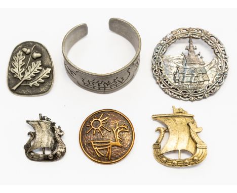 A collection of Norwegian white and gilt metal jewellery comprising brooches including two Viking ship versions along with a 