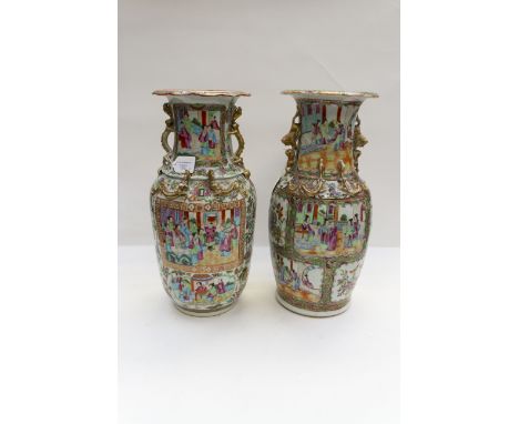 Two mid 19th Century Cantonese enamel baluster vases, twin zoomorphic handles, famille rose decorated with panels of domestic