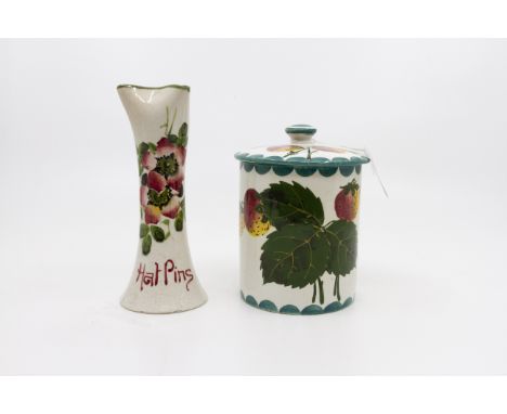 A Wemyss Hat Pin Vase with floral decoration, 15cm in height and a Wemyss Jam Pot decorated with fruit complete with lid 13cm