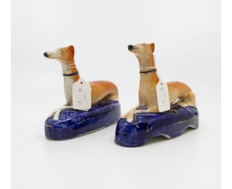 A pair of late Victorian Staffordshire greyhound figural pen stands (2)