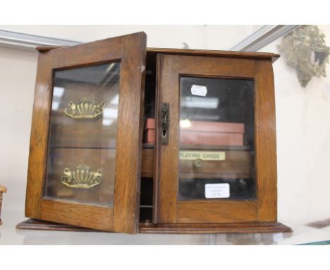 Oak smokers cabinet, circa 1930 including clay pipe