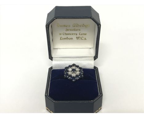 Unmarked white gold cluster ring size O/P. 5.6g. Postage cat A