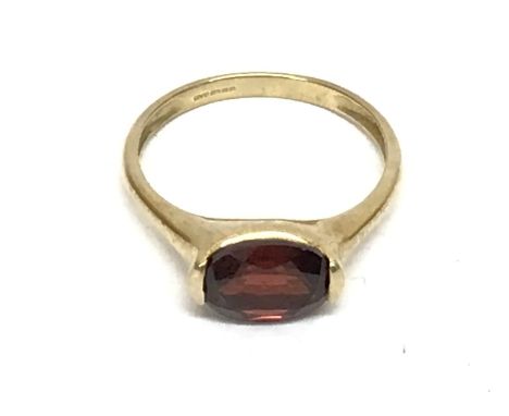 QVC 9ct gold ring set with a dark red coloured stone, 3g. Size T postage cat A- NO RESERVE