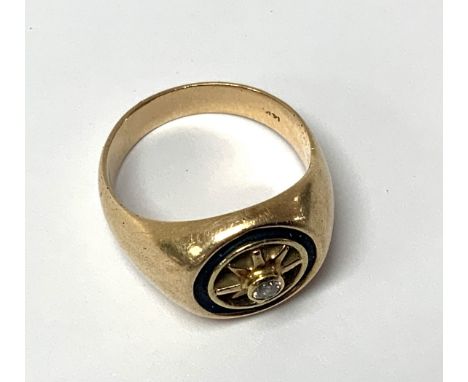 A gents 14k gold signet ring inset with a single diamond. Size R.5, 10.8g.