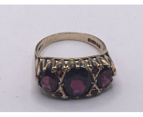 A 9carat gold ring set with three amethyst stones. Weight 4g NO RESERVE