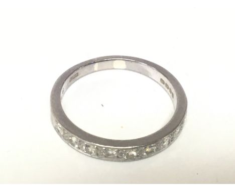 A white gold half hoop eternity ring set with a single row of white stones ring size O-P weight 4g