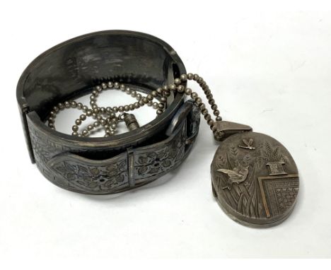 A Victorian aesthetic period silver locket together with a hallmarked silver bangle. (B)