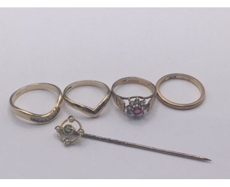 Four 9carat gold rings two set with small diamonds and a gold tie stick pin. Total weight 8g