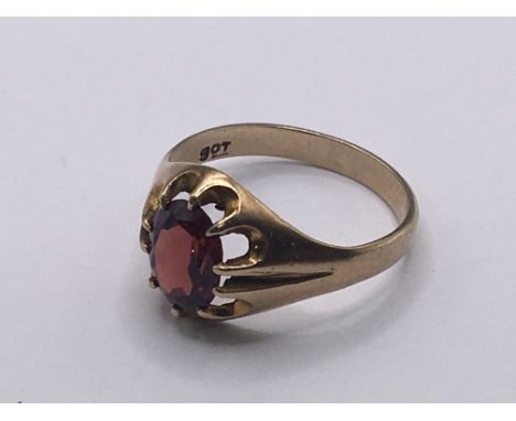 A 9carat gold ring set with a garnet.weight 3g- NO RESERVE