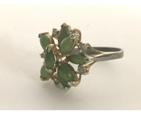 A 9carat gold ring set with jade cabochon and small brilliant cut diamonds ring size N-O