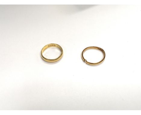 A pair of 22ct bands (one is split). Approx 5.0grams. Size of split band, K. Size of complete band J.