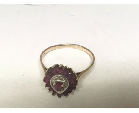 A 9carat gold ring set with a pattern of ruby and chip diamond.ring size S.