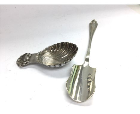 A silver tea caddy spoon and silver chase spoon.