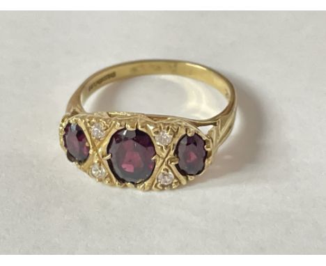 A 9ct gold ring inset with 3 garnets