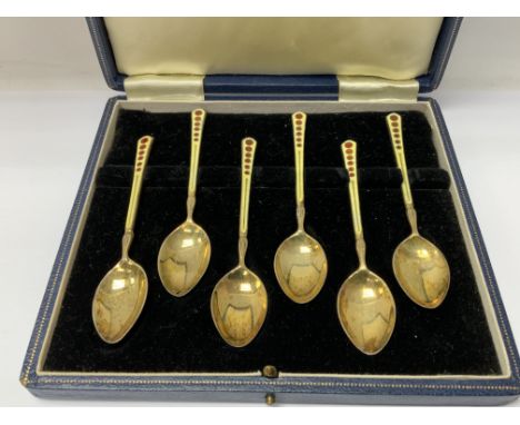 A cased set of 6 silver gilt and enamel coffee spoons (A).- NO RESERVE