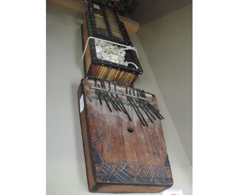 An early 20th century Anglo Indian quill box containing cut polished shells, and an ethnic musical metal keyboard