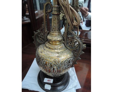 An early 20th century brass table lamp of Middle Eastern design having typical decoration
