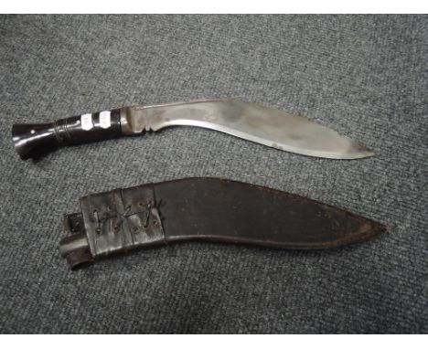 A Ghurkha Kukri in scabbard, steel blade, bone handle     