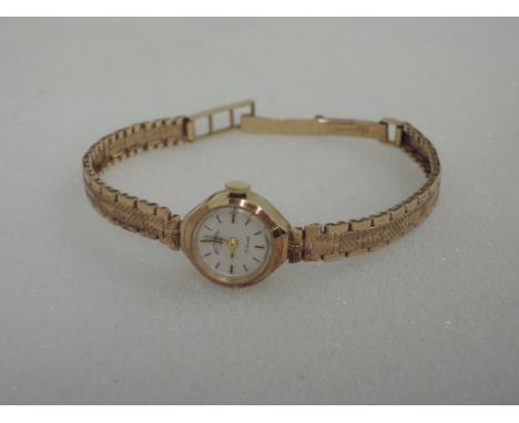 A ladies 9ct gold wrist watch by Rotary having a baton dial to face on a brick style articulated strap,  approx 13g
