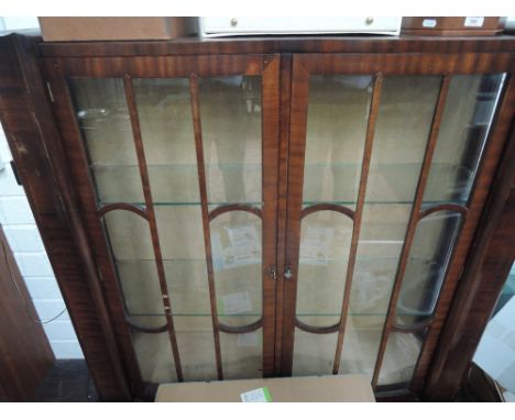 A 1930's mahogany display cabinet in the Art Deco style having recessed top