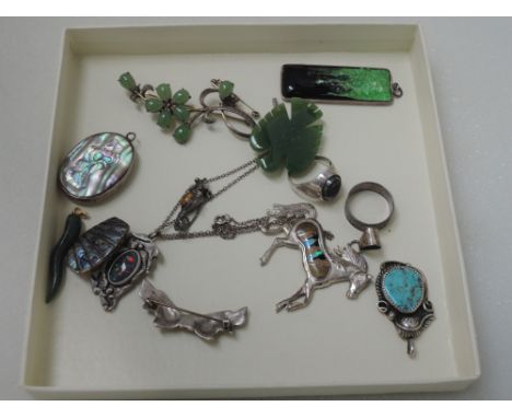 A selection of white metal jewellery including a Japanese jade floral brooch, hematite HM silver signet ring, pendants includ