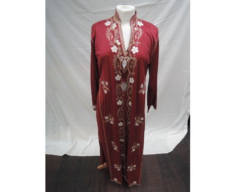 A Moroccan red celebration kaftan with under dress and sash having gold and white thread embroidery